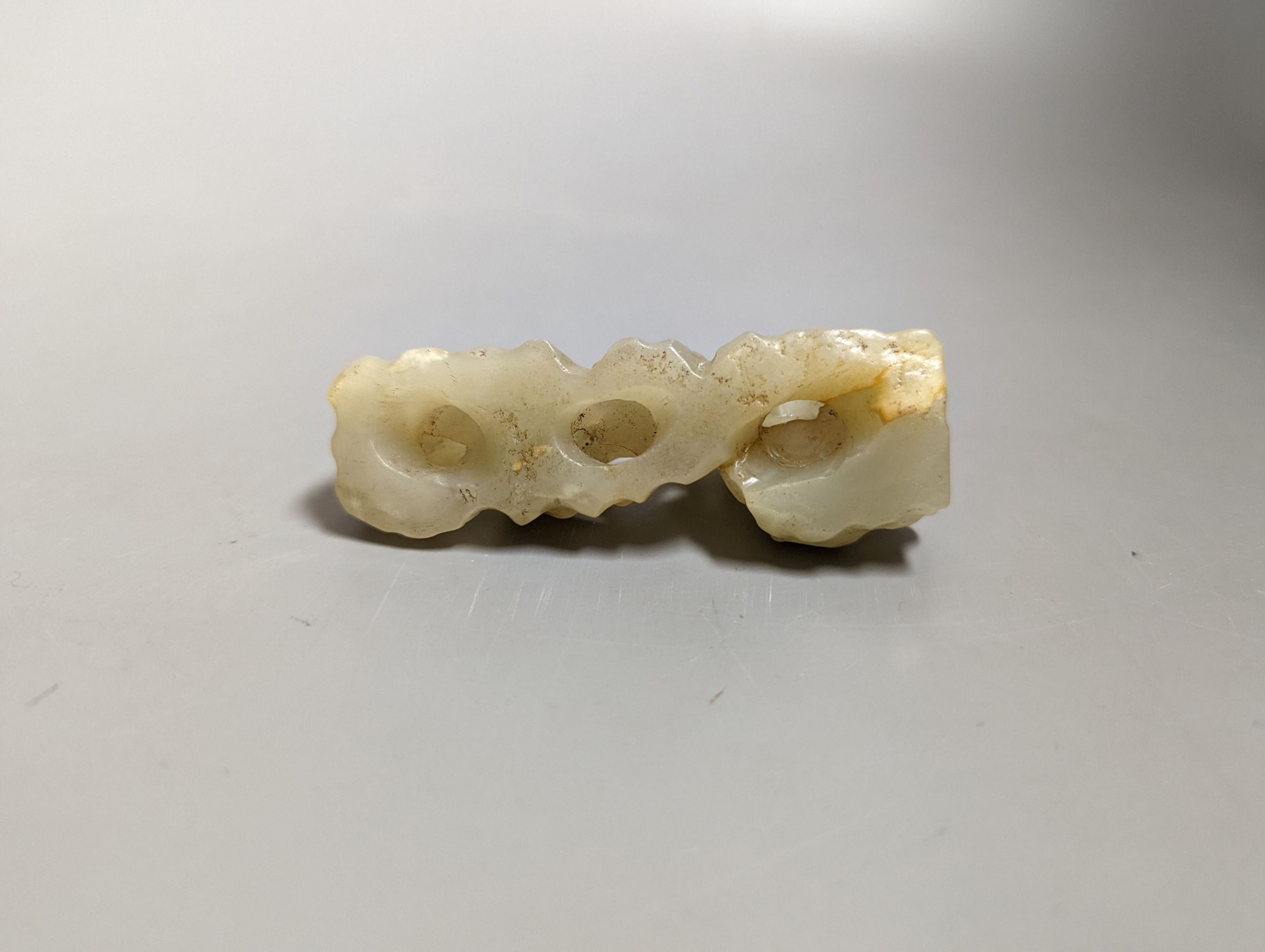 A Chinese celadon jade brush rest, 8cms wide